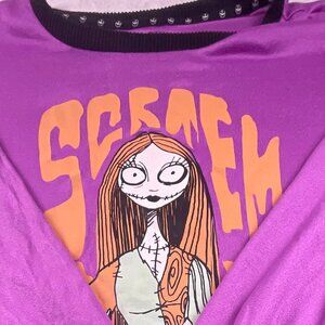 A purple long‑sleeve Nightmare Before Christmas top